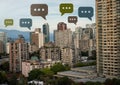 Chat bubble icons over city Royalty Free Stock Photo