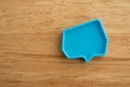 Chat bubbles on social media communication. Blue chat bubbles icon messages on wooden background minimal style.