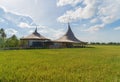 Chata Thammachart, a coffee shop in Sam Phran, Nakhon Pathom Province, Thailand. Asian paddy rice in green agricultural fields in