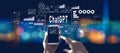 Chatbot ChatGPT - Aartificial Iintelligence theme with person using a smartphone at night
