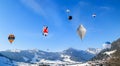 Colorful hot air balloons flying and floating over the Swiss Alps village Chateau d`oex