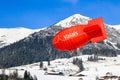 The red balloon from the Tourism Bureau of Canton Valais is flying and floating over the Swiss Alps