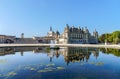 Chateau de Chantilly with reflection in a pond - France