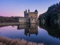 Chateau de la Roche castle Castle in Saint-Priest-la-Roche, France reflected in water at sunset Royalty Free Stock Photo