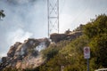 Firefighters climb rocks in the middle of a brush fire in Chatsworth, California