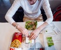 View from above of curious impatient woman eating McDonalds Royalty Free Stock Photo