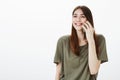 Chatty friendly girl likes talking on mobile phone. Portrait of happy carefree woman in casual outfit, smiling and
