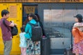 Asian family is standing in front of yellow self-service storage