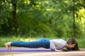 Chaturanga dandasana yoga pose in park alley