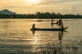 Chau Doc, Vietnam - Oct 14, 2018: Fisher men fishing on a fishing boat in river in Mekong Delta on floating water season at sunset Royalty Free Stock Photo