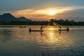 Chau Doc, Vietnam - Oct 14, 2018: Fisher men fishing on a fishing boat in river in Mekong Delta on floating water season at sunset Royalty Free Stock Photo