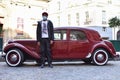 Chauffer, Driver with Red Old Timer in Paris, France Royalty Free Stock Photo