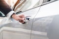 Chauffeur s hand on handle. Close-up of man in formal wear opening a passenger car door Royalty Free Stock Photo