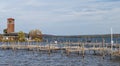 Chautauqua Lake, New York, USA October 5, 2023 An empty dock with seagulls on it on Chautauqua Lake with the Miller Bell Tower