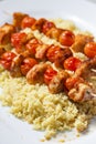 chcicken meat and tomato skewers with couscous Royalty Free Stock Photo