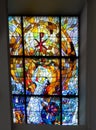 CheÃâm, Poland, June 8, 2022: Stained glass window in the window of the church, the shrine of the Mother of God in CheÃâm in