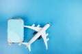 Cheap flight booking, airplane tickets, international flights, travel and trips, plane and luggage on a blue background with copy Royalty Free Stock Photo