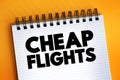 Cheap Flights text on notepad, concept background