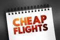 Cheap Flights text on notepad, concept background