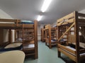 Cheap hostel room with wooden bunk beds Royalty Free Stock Photo