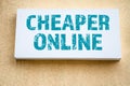 Cheaper Online. Advertising sign on the wall of a yellow building