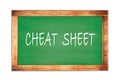 CHEAT SHEET text written on green school board