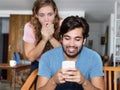 Cheating hipster man with shocked girlfriend