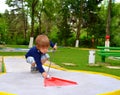 Cheating in mini golf Royalty Free Stock Photo