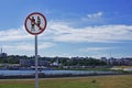 Forbidden sign `No swimsuit` on the background of the blue sky with clouds and the city view of Cheboksary