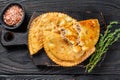 Cheburek meat pastry pie with herbs. Black wooden background. Top view