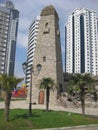 Chechen battle tower Vainakh in the center of Grozny on the background of modern high-rise buildings.