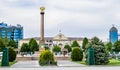 Chechen Republic. Monument `Grozny - a city of military glory` on the Abubakar Kadyrov Square and city mayor`s office with portra