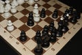 Chechered board with white chessmen for skill theme Royalty Free Stock Photo