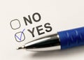 Check boxes yes or no on white paper. checkbox YES. marked with tick mark and blue pen on white paper background. Checking Yes. Royalty Free Stock Photo