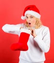 Check contents of christmas stocking what she received. Christmas stocking concept. Girl cheerful face check out gift in Royalty Free Stock Photo