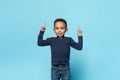 Check this. Glad black little boy pointing up at free space with two hands and smiling, child demonstrating place for ad