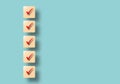 Check mark with brown square on pastel blue background, Concept for check list and checkmarks.