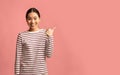 Check This Offer. Excited Young Asian Woman Pointing Aside With Thumb Up