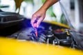 Check the oil level in yellow car engine. Mechanic checking car engine or vehicle. Check and maintenance car with yourself Royalty Free Stock Photo