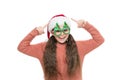 Check this out. Christmas holiday. Small girl in santa hat. Having fun. Happy child christmas tree eyewear accessory