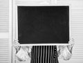 Check out cooking tips. Chef hold blackboard copy space hide face behind. Recipe concept. Cooking delicious meal step by
