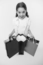 Check out her profitable purchases. Girl carries shopping bags yellow background. Girl fond of shopping. Child cute Royalty Free Stock Photo