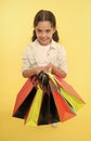 Check out her shopping packages. Child cute shopaholic with bunch shopping bags black friday total sale. Take shopping Royalty Free Stock Photo