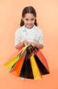 Check out her shopping packages. Child cute shopaholic with bunch shopping bags black friday total sale. Take shopping Royalty Free Stock Photo