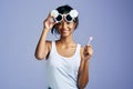 Check out my sweetness. Studio portrait of a beautiful young woman sucking on a lollipop against a purple background. Royalty Free Stock Photo