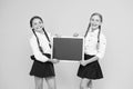 Check this out. School girls cute pupils hold blackboard copy space. School announcement concept. Classmates initiative