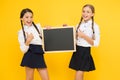 Check this out. School girls cute pupils hold blackboard copy space. Classmates initiative team yellow background. Join