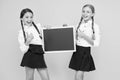 Check this out. School girls cute pupils hold blackboard copy space. Classmates initiative team yellow background. Join