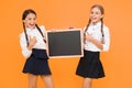 Check this out. School girls cute pupils hold blackboard copy space. Classmates initiative team yellow background. Join