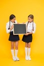 Check this out. School girls cute pupils hold blackboard copy space. Pupils community. Classmates initiative team yellow